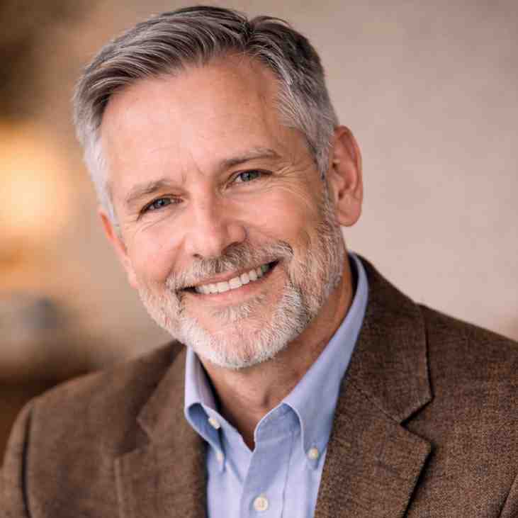 GraceVoice Older man with short gray hair and a warm smile